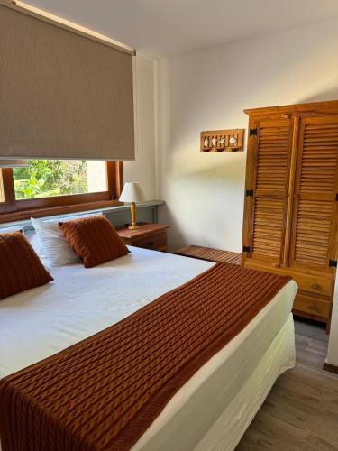 a bedroom with a large bed and a window at Apartamento Barra VIP in Marau