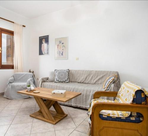 a living room with a couch and a table at Seafront & Sunsets Sigri House in Sígrion