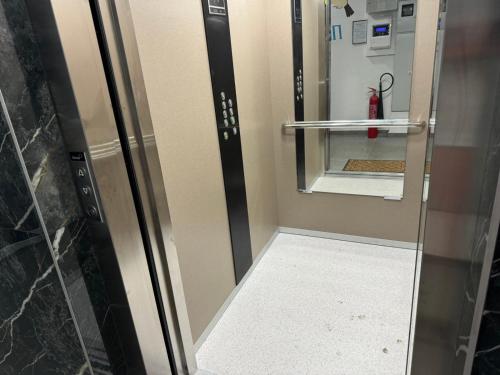 a elevator with a glass door and a fire hydrant at Apartman CITY CENTER 5 in Prijedor