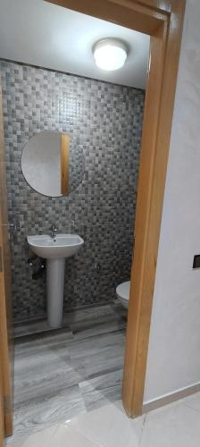 a bathroom with a sink and a toilet at La Maison Attawba in Beni Mellal