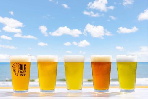 a row of beer glasses on a table near the beach at Hilton Garden Inn Ocean City Oceanfront in Ocean City