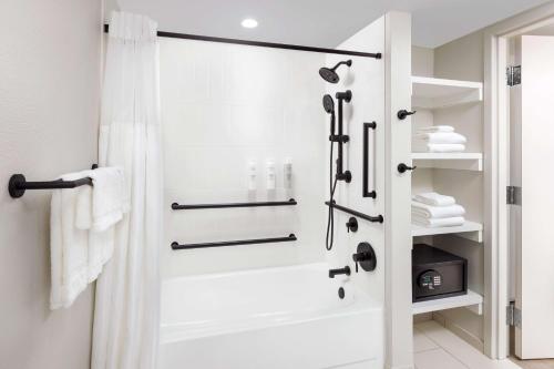 a bathroom with a shower with a glass door at Hilton Garden Inn Ocean City Oceanfront in Ocean City