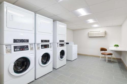 a laundry room with white washers and dryers at Hilton Garden Inn Ocean City Oceanfront in Ocean City