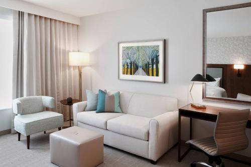 a living room with a couch and a chair in a hotel room at TownePlace Suites by Marriott Orlando Downtown in Orlando