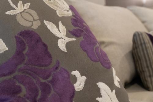 a pillow with purple and white flowers on it at Infinity Suites Habitación Triple 105 in Cancún