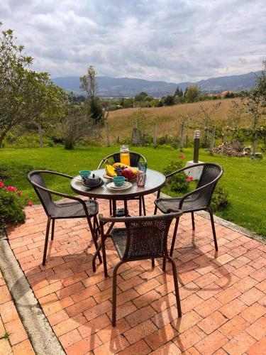 a table and two chairs on a brick patio at Hacienda La Yegüera in Subachoque