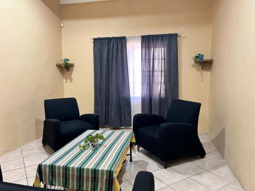 a room with a table and two chairs and a window at Your Comfortable Home Away From Home in Fouriesburg