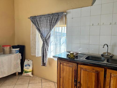 a kitchen with a sink and a window at Your Comfortable Home Away From Home in Fouriesburg
