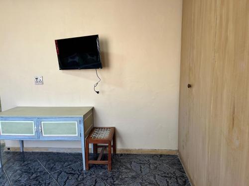 a room with a desk and a tv on a wall at Your Comfortable Home Away From Home in Fouriesburg