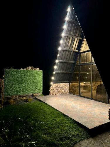 a building with a large window at night at Pika 04 by Pika cabins con Piscina privada in San Carlos