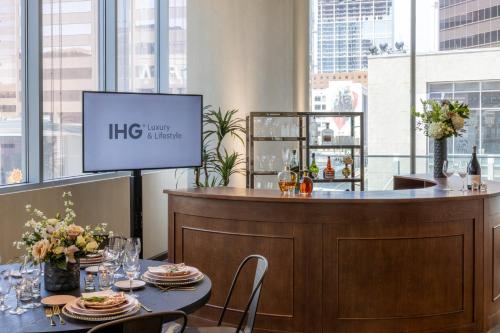 a restaurant with a bar with a menu on a screen at Kimpton Hotel Palomar Phoenix Cityscape by IHG in Phoenix