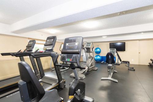 a gym with several tread machines in a room at Sandman Signature Lethbridge Lodge in Lethbridge