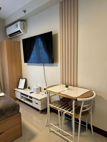 a living room with a table and a tv at AR's STAYCATION in Lapu Lapu City