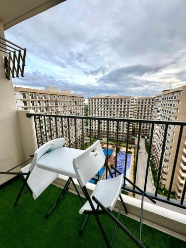 a balcony with two chairs and a table on a balcony at AR's STAYCATION in Lapu Lapu City