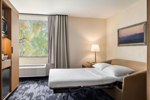 a hotel room with a bed and a window at Fairfield by Marriott Inn & Suites Madison South in Madison