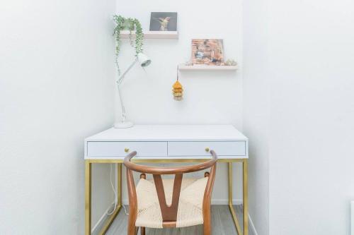 a desk with a chair next to a white wall at Private retreat close to JTNP and downtown in Joshua Tree