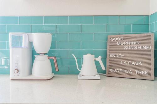 a kitchen counter with two appliances next to a sign at Private retreat close to JTNP and downtown in Joshua Tree