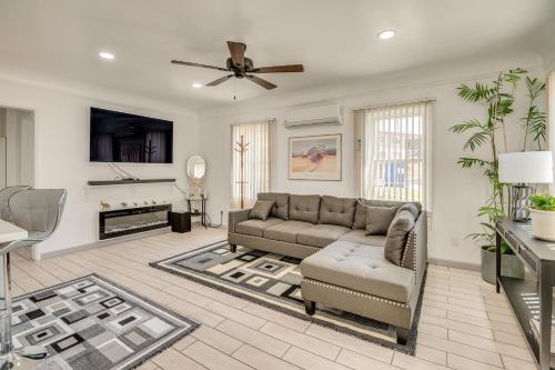 a living room with a couch and a ceiling fan at 2 Mi to SoFi Stadium Updated Inglewood Home! in Los Angeles