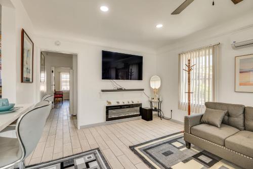 a living room with a couch and a fireplace at 2 Mi to SoFi Stadium Updated Inglewood Home! in Los Angeles