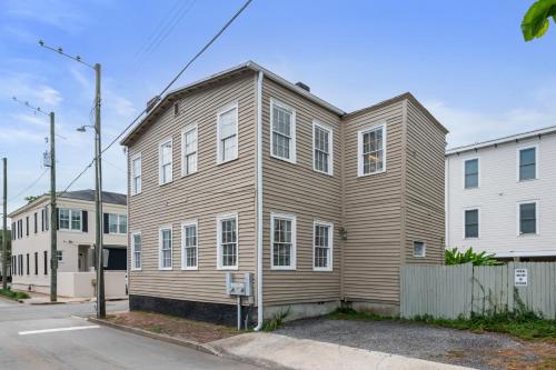 a large wooden house on the corner of a street at Charming Savannah Duplex Courtyard Parking in Savannah
