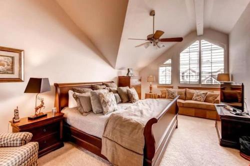 a bedroom with a large bed and a couch at Ski, In Ski Out 3 Bedroom Vacation Condo With Resort Amenities That Include Exercise Center, Indoor Pool, And Hot Tubs in Beaver Creek