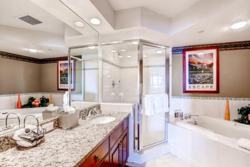 a bathroom with two sinks and a tub and a shower at Beaver Creek St James 4 Bedroom in Beaver Creek