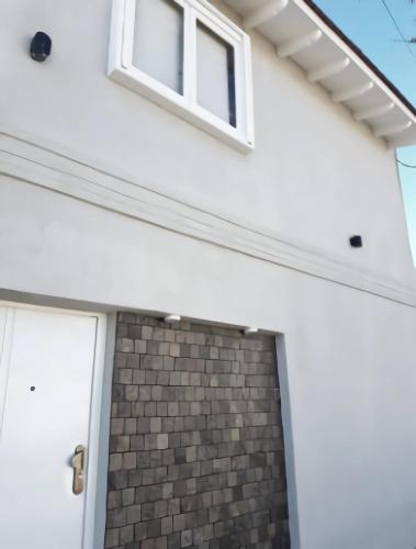 a white garage door with a window on top at Departamento Loft completo, cómodo y luminoso. in Neuquén