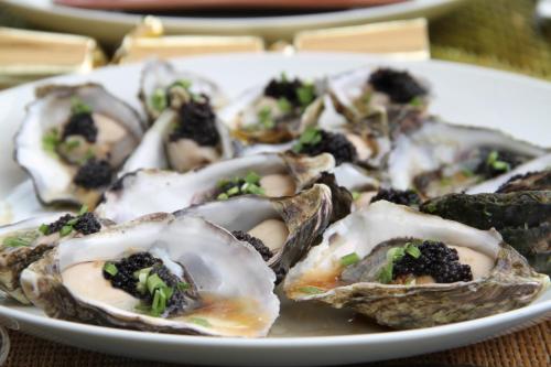 a plate of oysters with broccoli on a table at Blair Athol Estate Wollombi in Wollombi