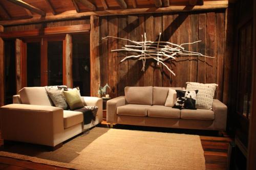 a living room with two chairs and a couch at Blair Athol Estate Wollombi in Wollombi