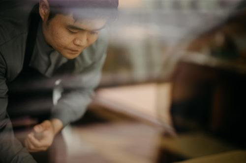 a man is looking down at a table at JW Marriott Jeju Resort & Spa in Seogwipo