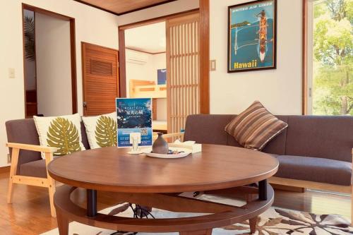 a living room with a table and a couch at 星光の城 船でアクセス友人との集まりに最適なリラックスできる秘境 in Hinase
