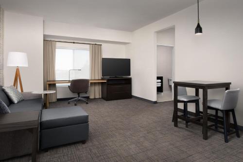 a living room with a couch and a table at Residence Inn by Marriott Fresno Clovis in Clovis