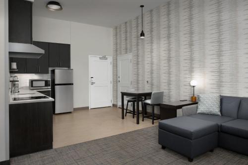 a kitchen and living room with a couch and a table at Residence Inn by Marriott Fresno Clovis in Clovis