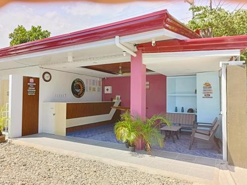 a small house with a red roof at 3 Sisters Guest House 1 in Moalboal