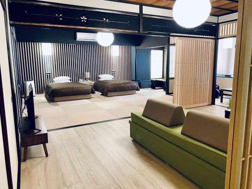 a living room with two beds and a couch at Hotel Clio Court Hakata in Fukuoka
