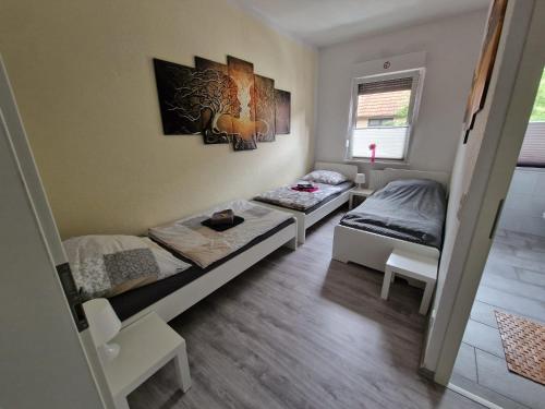 a room with two beds and a table in it at Ostwind in Bochum