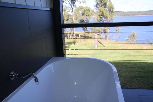 a bath tub in a bathroom with a large window at Dusty Hill Vineyard - Moffatdale in Moffatdale