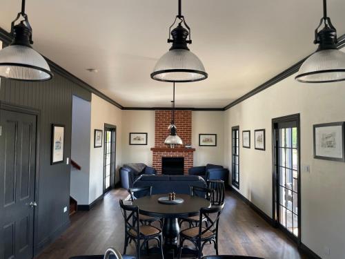 a living room with a couch and a table and chairs at Dusty Hill Vineyard - Moffatdale in Moffatdale