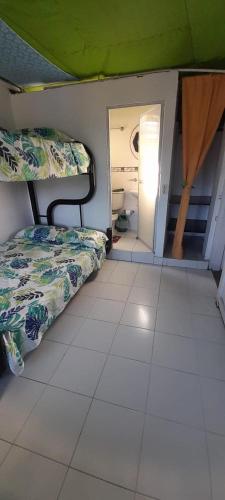 a room with two beds and a hallway with a mirror at MANOA "Lugar de descanso" HABITACION CON VISTA A LA CIUDAD, FRESCO Y VENTILADO in Ibagué