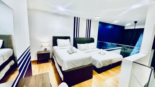a hotel room with two beds and a balcony at EkoCheras Suites, Kuala Lumpur 1-4 Pax in Kuala Lumpur