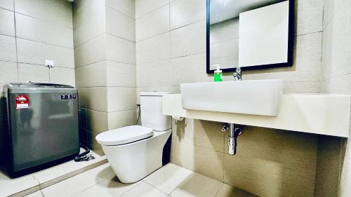 a bathroom with a toilet and a sink and a mirror at EkoCheras Suites, Kuala Lumpur 1-4 Pax in Kuala Lumpur