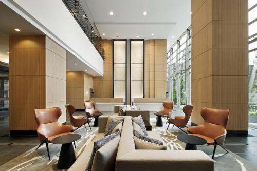 a lobby with chairs and couches in a building at Fairfield by Marriott Sapporo in Sapporo