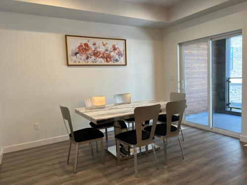 a dining room with a table and chairs at Modern Town House, 3-Bedrooms Home private parking in Draper