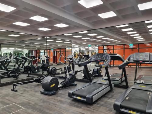 a gym with lots of treadmills and elliptical machines at Soléa Hotel & Serviced Apartment Sunset Town Phu Quoc in Phu Quoc