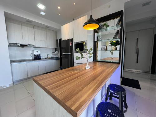 a kitchen with a wooden counter top in a room at RiverView 8PAX 3BR in KBtown PS4, Netflix A-11-3 in Kota Bharu