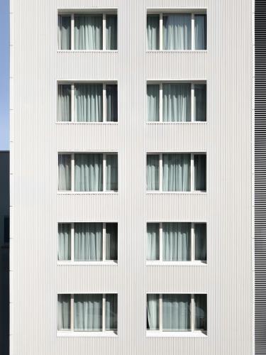 a facade of a white building with windows at Hotel Hello Plovdiv - Free Parking and Pet Friendly in Plovdiv