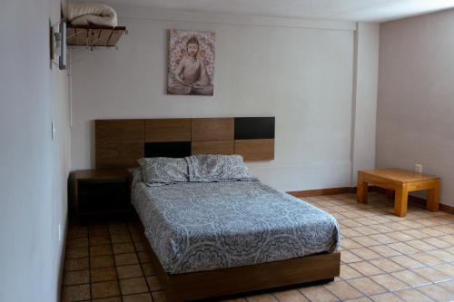 a bedroom with a bed and a statue on the wall at Hotel Casa Barcelona San Luis Potosí in San Luis Potosí