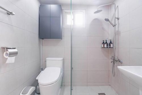 a bathroom with a shower and a toilet and a sink at Namsan Tower View - duplex, 3rooms 2toilets in Seoul