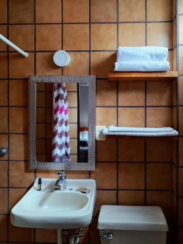 a bathroom with a sink and a toilet at Hotel Casa Barcelona San Luis Potosí in San Luis Potosí