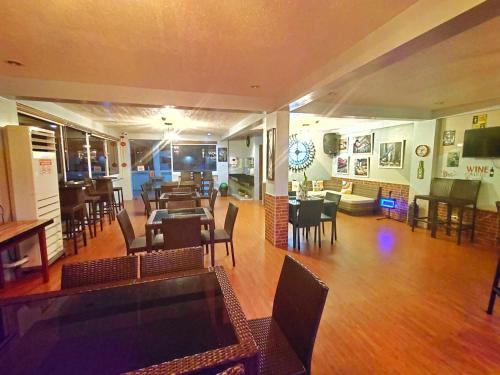 a restaurant with tables and chairs and a dining room at Funtasea Hotel and Beach Resort in Iba
